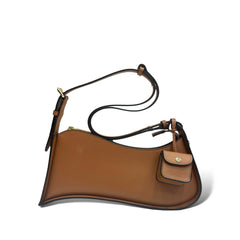 Multi-Tone Asymmetrical Curved Slim Shoulder Carry Vessel Diminutive Snap Pouch Dangling Accent and Sleek Sealed Top Track Handbag